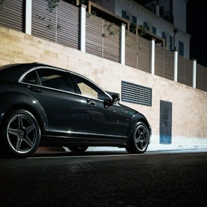 Black executive sedan at night